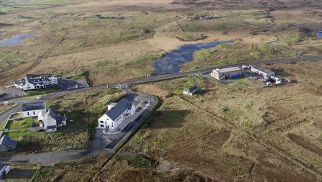 Downward-facing-drone-shot-of-the-Cnoc-Soilleir-building-near-Lochboisdale-in-South-Uist,-part-of-the-Outer-Hebrides-of-Scotland