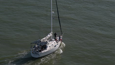Top-down-view-of-a-sailboat-from-the-Kemah-bridge-heading-out-to-Galveston-Bay-by-Kemah-Boardwalk-in-Kemah-Texas