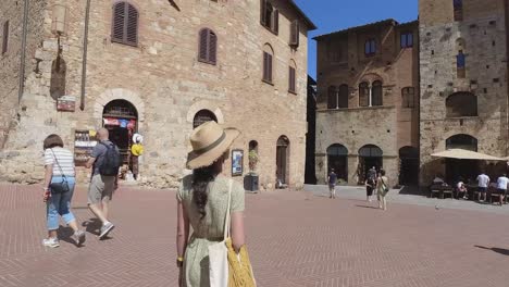 Beautiful-female-model-walking-in-the-city-Centre-of-San-Gimignano---Tuscany