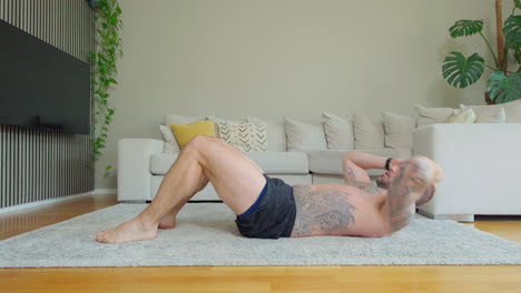 Shirtless-Man-With-Tattoo-Doing-Sit-Ups-and-Crunches-Exercising-Abdominal-Muscles