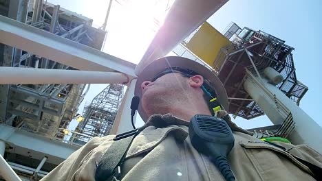 Crew-Member-operating-drone-equipment-near-a-crane-on-an-offshore-oil-rig