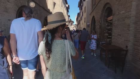 Beautiful-female-model-walking-within-the-streets-of-San-Gimignano-in-Tuscany