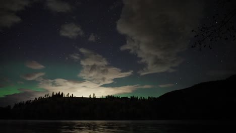 Enchanting-Northern-Lights-above-serene-lake-at-night