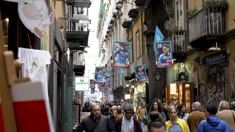 Naples-Street-With-Football-Club-Posters-Of-Stars-Hanging-As-Tourists-Walk-Past