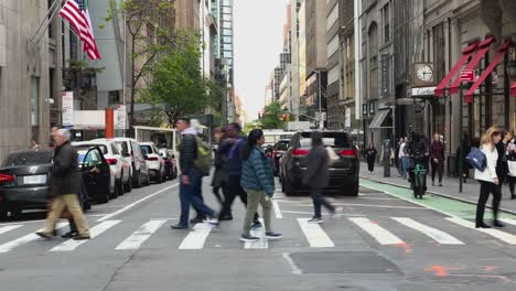POV-View-Of-Daily-Street-Scene-On-5th-Avenue-With-Pedestrians-And-Traffic-Going-Past
