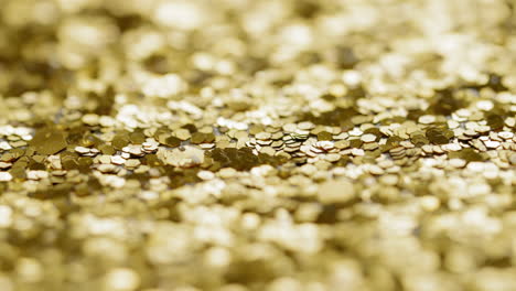 Macro-sliding-view-of-gold-glitter
