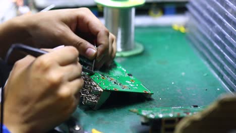 The-engineer-is-soldering-the-inputs-to-the-motherboard