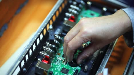 engineer-installs-capacitor-on-motherboard