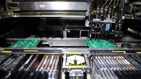 assembling-the-motherboard-components-by-the-machine,-inside-of-the-machine