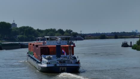 The-cargo-ship-Amira-glides-through-the-waters-near-the-town-of-Zwijndrecht,-its-towering-structure-and-powerful-engines-a-testament-to-the-marvels-of-modern-engineering