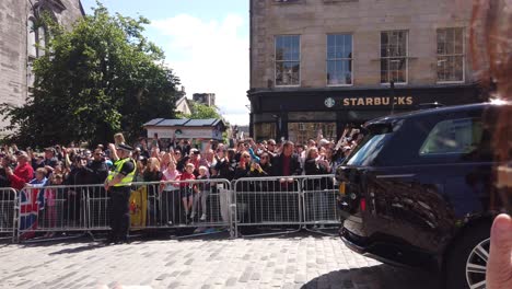 The-British-Royal-family-drive-very-quickly-past-an-Edinburgh-crowd