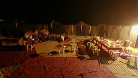Timelapse-video-from-Morocco,-Sahara-Desert,-Merzouga,-group-of-people-enjoying-the-night-in-the-camp