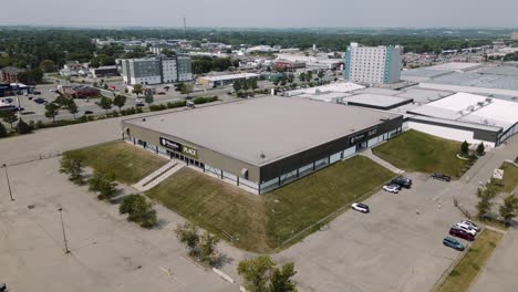 A-4K-Aerial-Cinematic-Drone-Shot-of-Busy-City-18th-Street-Downtown-Westoba-Place-Keystone-Center-Stadium-Wheat-Kings-Hockey-Arena-in-Prairies-Town-Brandon-Manitoba-Canada