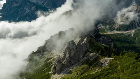 Aerial-hyperlapse-of-fog-drifting-over-and-around-pointed-rocky-peaks-in-the-Dolomite-mountains-of-Italy-during-the-day