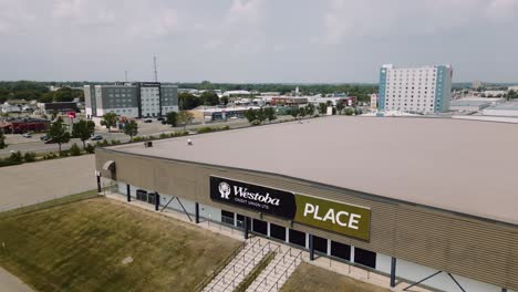 A-4K-Aerial-Reveal-Cinematic-Drone-Shot-of-Busy-City-18th-Street-Downtown-Westoba-Place-Keystone-Center-Stadium-Wheat-Kings-Hockey-Arena-in-Prairies-Town-Brandon-Manitoba-Canada