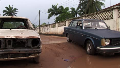 Old-car-stops-before-huge-puddle-on-a-road-in-Nigeria