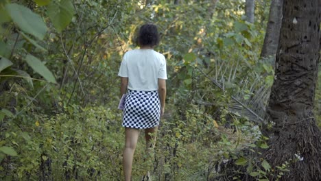 Cinematic-slow-motion-shot-of-a-model-in-a-white-shirt-and-black-and-white-chess-board-patterned-skirt-in-the-tropical-rainforest-of-Goa,-Fashion,-Slomo