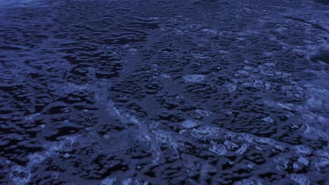 aerial-view-of-frozen-blue-ice-on-lake-superior-at-twilight