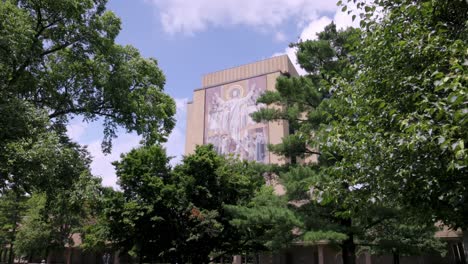 Hesbaugh-Library,-Touchdown-Jesus,-on-the-campus-of-Notre-Dame-University-in-South-Bend,-Indiana-with-gimbal-video-walking-forward