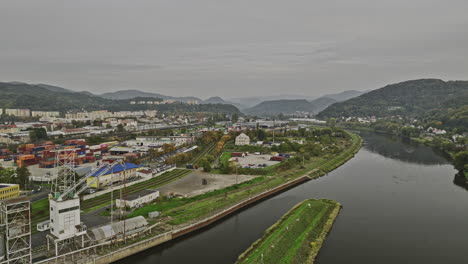 Usti-nad-Labem-Czechia-Aerial-v1-drone-flyover-Elbe-river-channel-capturing-panoramic-views-of-riverside-industrial-area,-quarry-site-and-hillside-cityscape---Shot-with-Mavic-3-Cine---November-2022