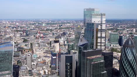 Close-up-aerial-view-of-the-City-of-London-towers-including-the-Walkie-Talkie-building,-Gherkin,-Leadenhall-and-views-of-the-River-Thames-and-the-Shard,-London,-UK