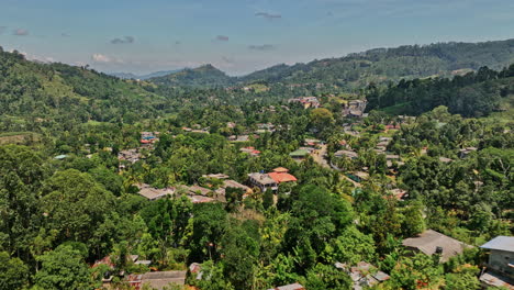 Pussellawa-Sri-Lanka-Aerial-v4-low-level-drone-flyover-village-town-along-A5-road-capturing-hillside-tea-plantations-and-mountainous-landscape-on-a-sunny-day---Shot-with-Mavic-3-Cine---April-2023