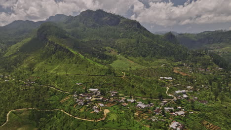 Palagolla-Sri-Lanka-Aerial-v2-cinematic-drone-flyover-mountain-highlands-capturing-small-hillside-villages,-lush-green-landscape-covered-in-tea-plantations---Shot-with-Mavic-3-Cine---April-2023