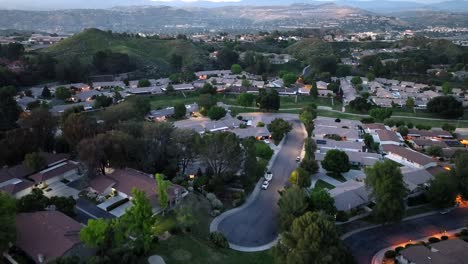 Aerial-view-flying-over-Santa-Clarita-wealthy-city-suburb-neighbourhood-during-sunset