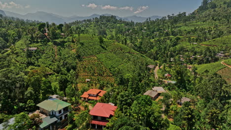 Pussellawa-Sri-Lanka-Aerial-v3-low-drone-flyover-Rothschild-Tea-Estate-surrounded-by-lush-green-hills-and-tea-plantations-capturing-beautiful-hilly-landscape---Shot-with-Mavic-3-Cine---April-2023