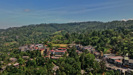 Pussellawa-Sri-Lanka-Aerial-v1-flyover-village-town-and-A5-road-towards-hillside-Rothschild-Tea-Estate,-capturing-highlands-tea-plantations-and-mountain-landscape---Shot-with-Mavic-3-Cine---April-2023