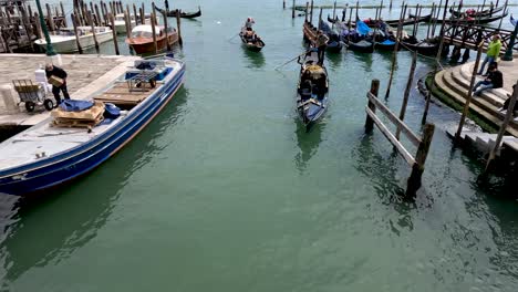 People-in-gondolas-going-under-Ponte-della-Paglia-along-Rio-di-Palazzo-in-Venice