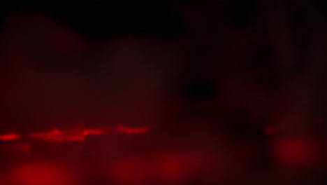 Rote-Flüssigkeitsflecken,-Die-Sich-Auf-Schwarzem-Hintergrund-Bewegen,-Abstrakter-Feuerhintergrund