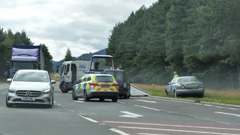 Serious-car-crash-on-a-Scottish-road-with-a-police-investigating-the-traffic-accident