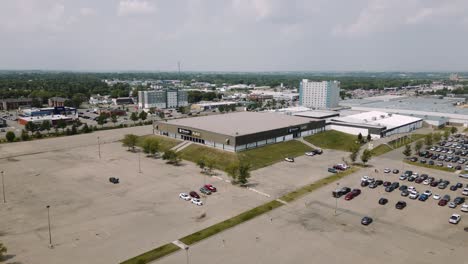 A-4K-Dolly-In-Aerial-Cinematic-Drone-Shot-of-Busy-City-18th-Street-Downtown-Westoba-Place-Keystone-Center-Stadium-Wheat-Kings-Hockey-Arena-in-Prairies-Town-Brandon-Manitoba-Canada