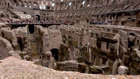 Interior-close-up-view-of-the-Colosseum-Arena-with-tourists-standing-in-the-background