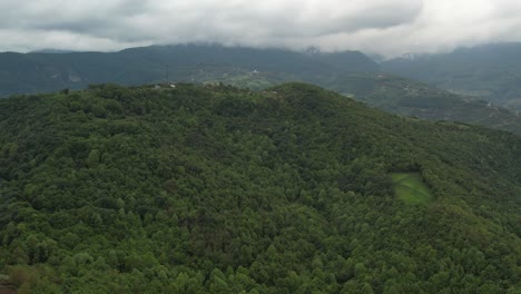 Aerial-view-of-green-mountain-peak-in-Macedonia,-summer-green-nature-forest-mountain-landscape-from-above-with-beautiful-view