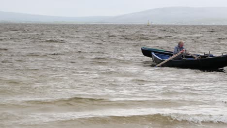 Solo-people-in-currach-traditional-boats-paddle-and-adjust-around-in-ocean
