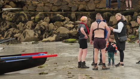 Group-of-friends-gather-and-congratulate-sharing-feelings-from-racing-currach-boats