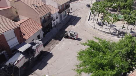 Aerial:-Roadwork-in-Navas-del-Rey,-Spain---Fixining-old-pavement-road