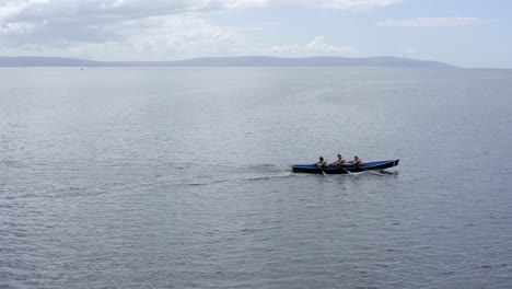 Sideview-tracking-follows-currach-paddlers-in-open-ocean-of-ireland