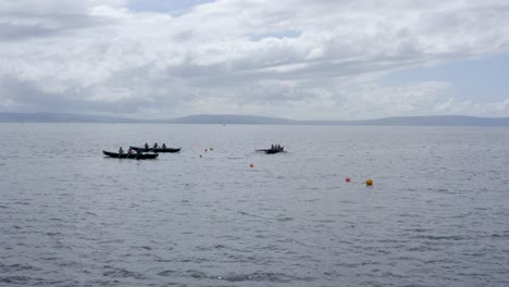 Currach-boats-paddle-approaching-towards-start-line-buoys-in-galway-ireland