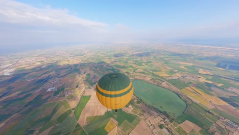 Breathtaking-FPV-aerial-drone-view-flying-high-around-a-hot-air-balloon-in-flight