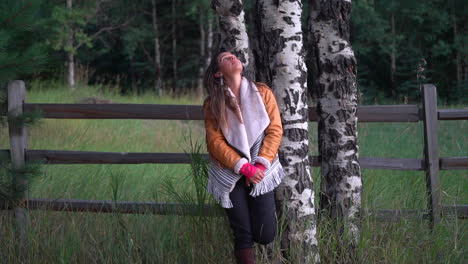 Cinematic-female-women-model-actress-cute-outfit-jacket-dark-brown-hair-pose-next-to-tall-fence-Aspen-trees-late-afternoon-Denver-Evergreen-Colorado-summer-sunset-golden-hour-handheld-follow