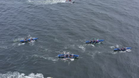 Side-bird's-eye-view-tracking-currach-boat-racing-teams-in-galway-ireland