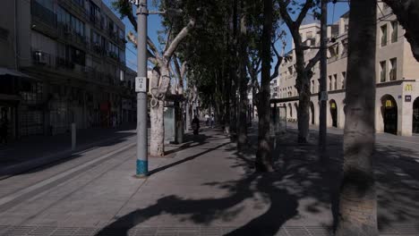Pedestrians-walking-in-the-city-between-light-rail-stations,-walking-POV
