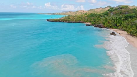 Aerial-view-showing-turquoise-colored-Caribbean-sea-at-PLAYA-DEL-AMOR-Beach,-Samana-in-summer