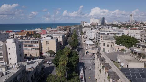 Tram-driving-through-suburban-Tel-Aviv,-aerial-establishing-shot