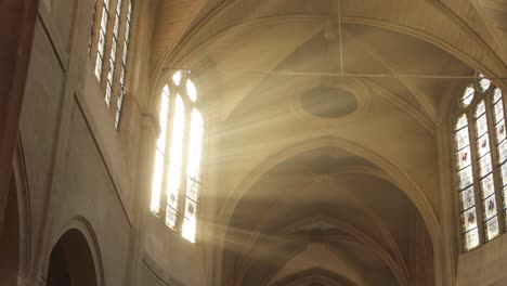 Church-of-Saint-Médard-in-Paris,-France-filled-with-rays-of-sunlight