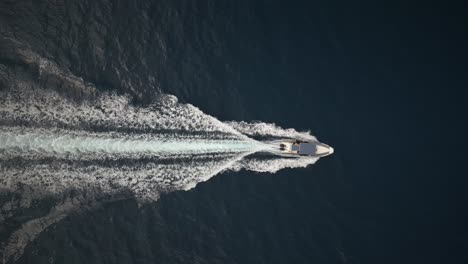 Small-rubber-Boat-top-Shot-drone-in-dramatic-ocean-creating-waves