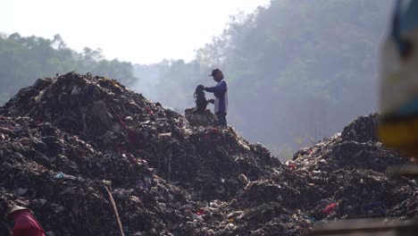 Scavengers-are-looking-for-goods-in-mountains-of-garbage,-Piyungan-final-disposal,-Yogyakarta